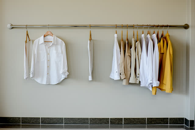 A school costume laundry room after rehearsal, empty of people, without storage bins, shelves, readable labels, or piles