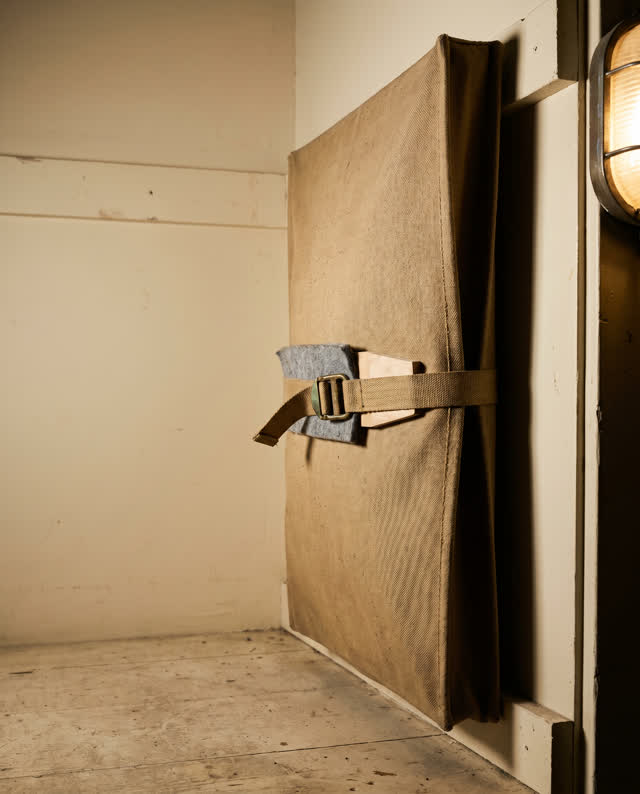 A theater mirror cover cloth storage corner after closing, empty of people, with no stage props, readable signs, labels,