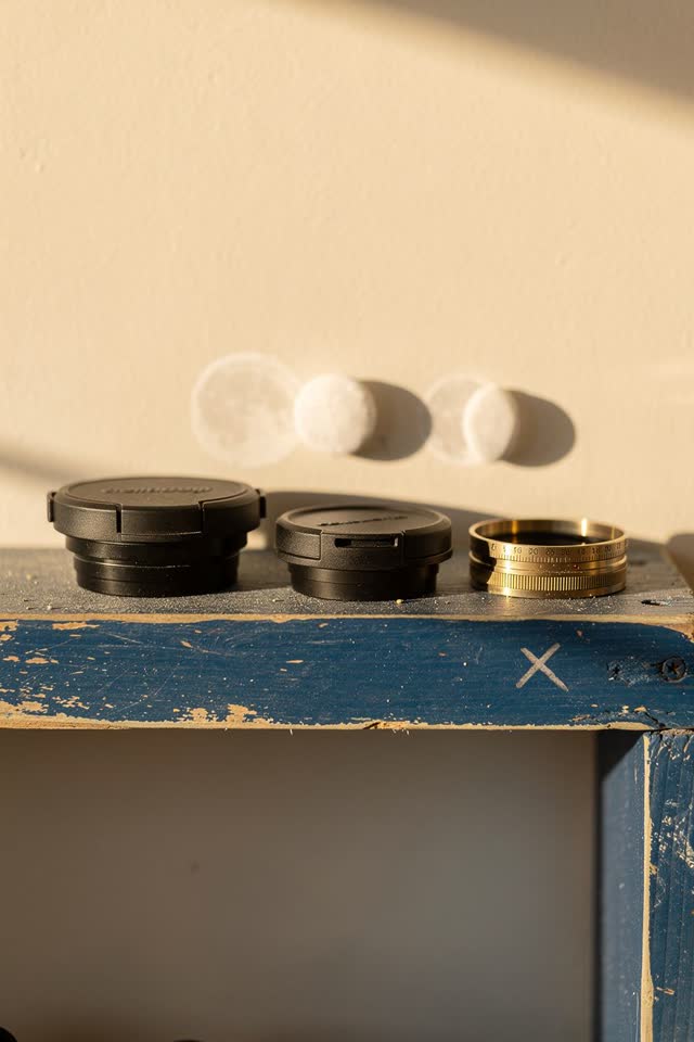 A small public observatory storage shelf in bright afternoon sun, empty of people, with no readable labels, no coat hook