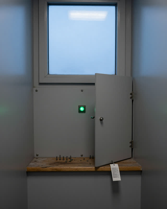 A restrained challenge in a narrow clean control alcove with daylight from a high practical window: a plain painted serv