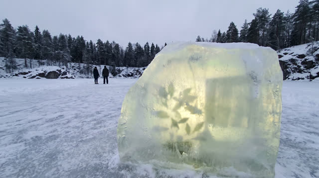 A buoyant first-person dream on a frozen quarry lake surrounded by dark winter woodland. One large naturally cloudy form