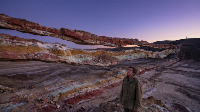 A spacious inviting dream across a vast dry mineral basin at violet dusk. Thin bands of iron red, gypsum white, ochre, a