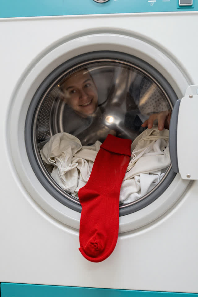 I dream of a bright laundromat where one front-loading washer has paused itself for balance. Through the round glass doo