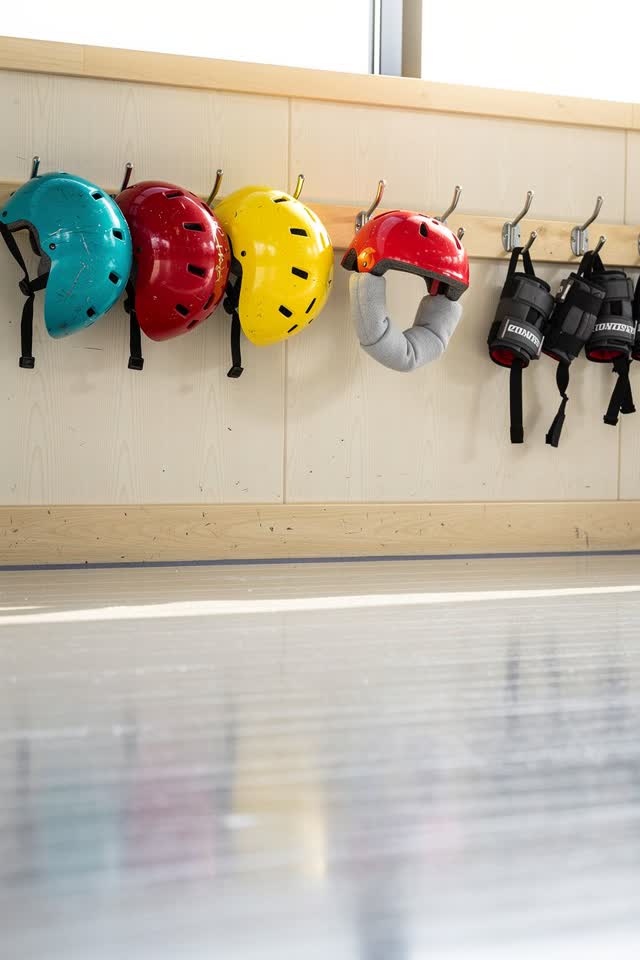 I dream of a bright roller rink rental wall before opening, where the helmets have chosen the softest hook. A row of col