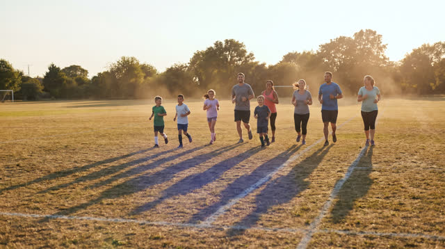 I dream of an open neighborhood soccer field in low golden evening light, where motion keeps going without becoming urge