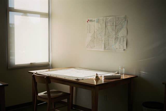 I dream of a narrow map-copy room at the end of a working day, where one high wooden stool stands pulled back from a bro