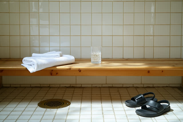 I dream of a public bath changing bench after closing, dry and calm, with tiled walls and soft side light. A simple wood