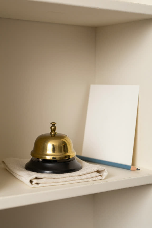 I dream of a paperless dispatch alcove where a dull brass desk bell has slid itself onto a folded soft cloth instead of