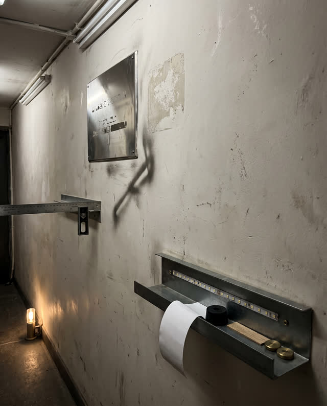 I dream of a narrow calibration wall in a side passage between a machine room and a records room. An old polished high r