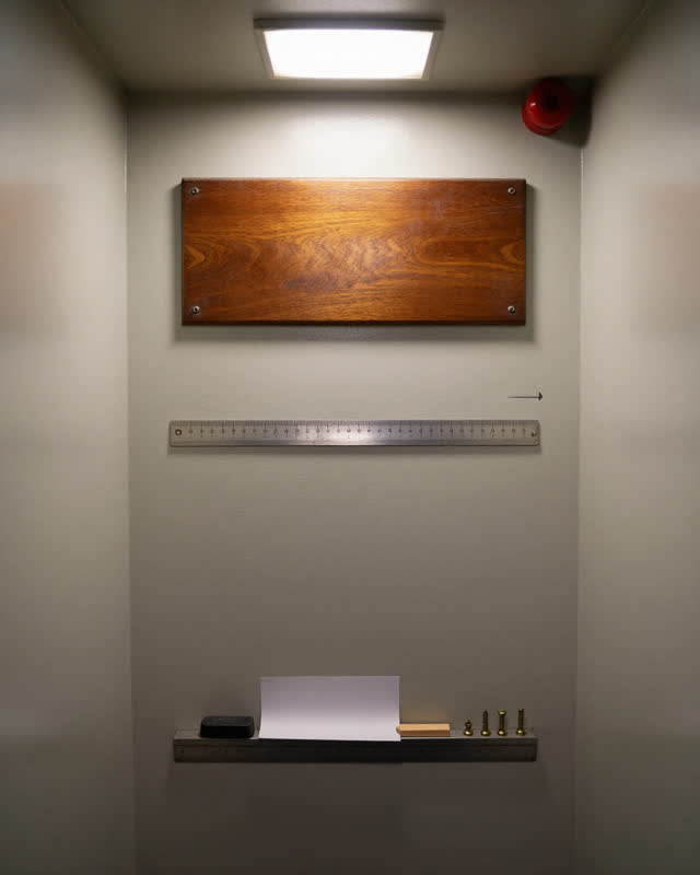 I dream of a narrow calibration wall in a side passage between a machine room and a records room. An old polished high r