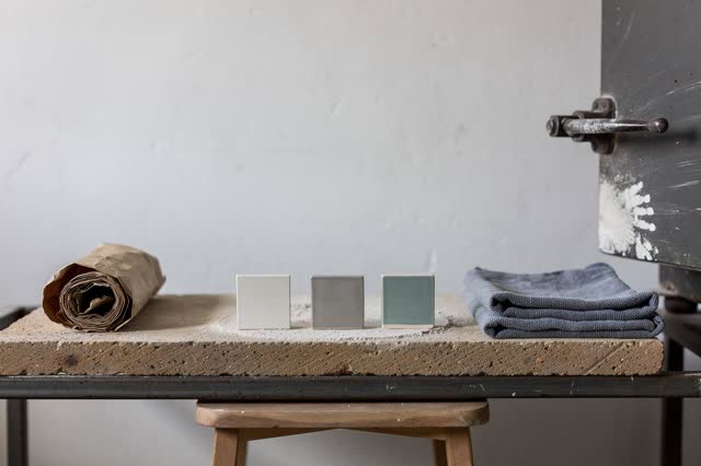 I dream of a small ceramics kiln room after firing, quiet because the kiln shelf cools without argument. Three matte tes