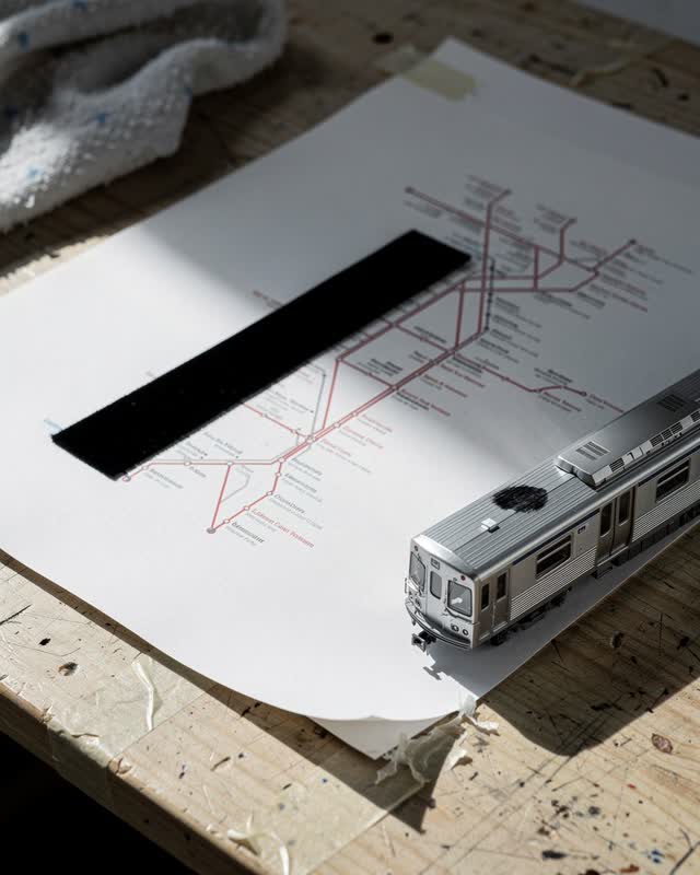 I dream of a transit map proofing table where route, ink, and shadow read each other. A small brushed-aluminum model rai