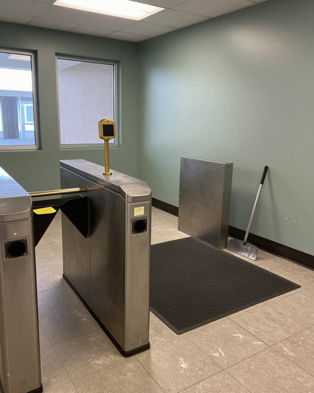 I dream of a quiet public building entry where the turnstile waits for the overlooked return path. A polished waist-high