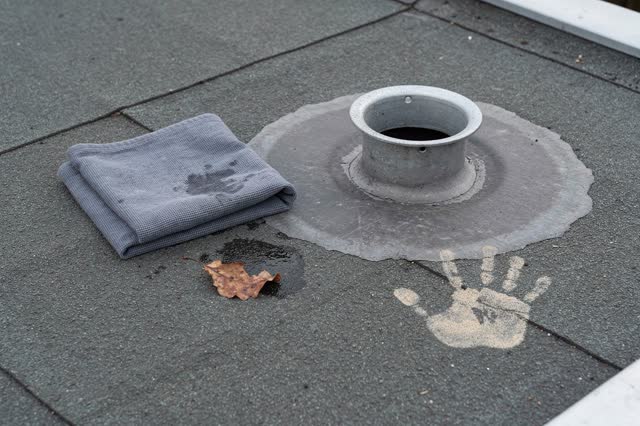 I dream of a flat rooftop corner after the drain has been cleared, quiet because the water has somewhere to go. A dull z