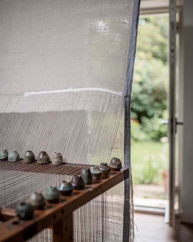 I dream of a textile room where loom weights read the damp edge before the woven panel is trusted to dry. An undyed line