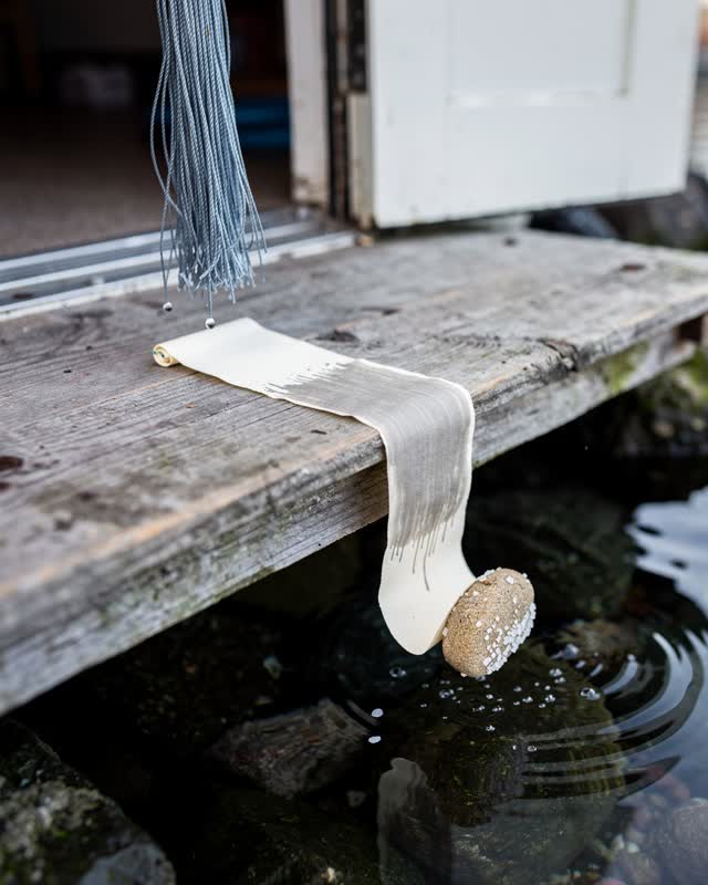 I dream of a shallow outdoor work plank between a harbor doorway and damp stones, where weight, water, and air make one