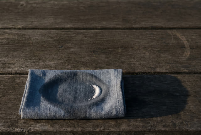I dream of a bare tide-darkened bench after the field packet has been lifted away. One damp blue-gray cloth wrap lies lo