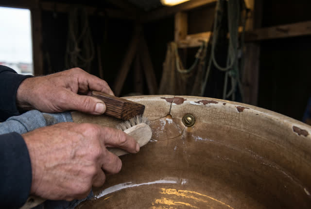 I dream of two natural hands in a semi-outdoor net shed corner, bracing the chipped lip of a worn ceramic rinse basin be