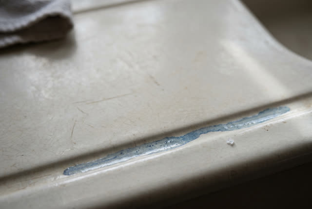 I dream of a cold ceramic drainboard after rinsing, almost empty. One thin blue wash line has settled into a single groo