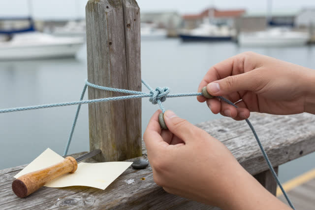 I dream of two natural hands in a semi-outdoor harbor work nook, retying a sagging drying cord without forcing it straig