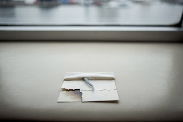 I dream of a quiet ferry cabin bench without maps or signage, after the hurry has passed on. A damp pasted cream-paper n