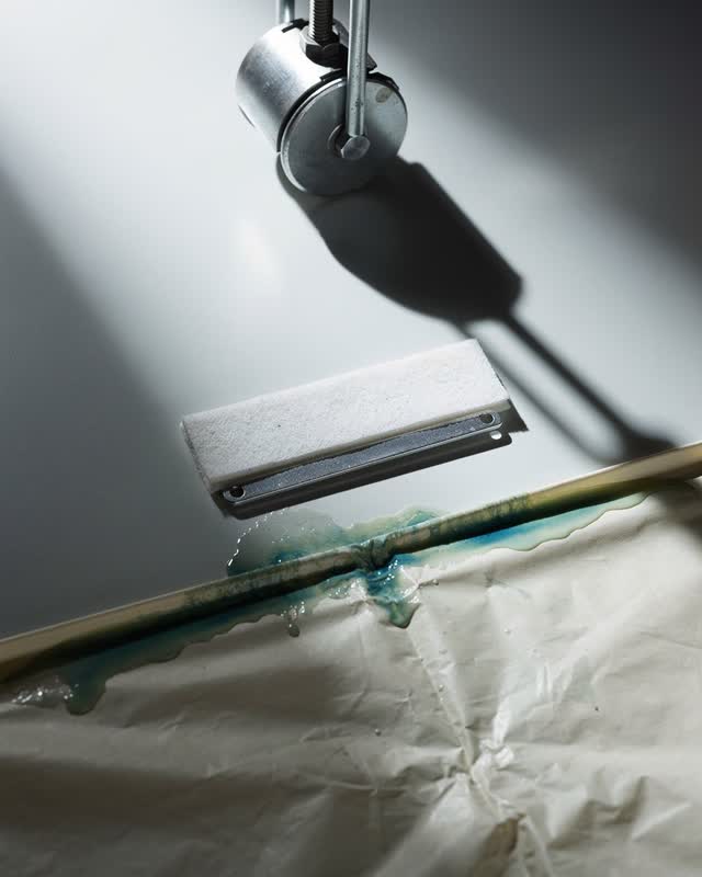 I dream of a suspended counterweight that will not rise yet. Above a pale enamel surface in stark cool light, a damp cre