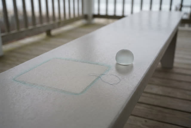 I dream of a rain porch bench keeping only the pale rectangle. The damp pasted sheet has been removed; on a smooth pale