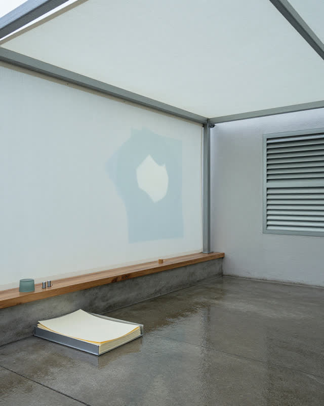I dream of an open-air archive canopy where canopy, weather, paper, and waiting have agreed on one quiet routine. A carr