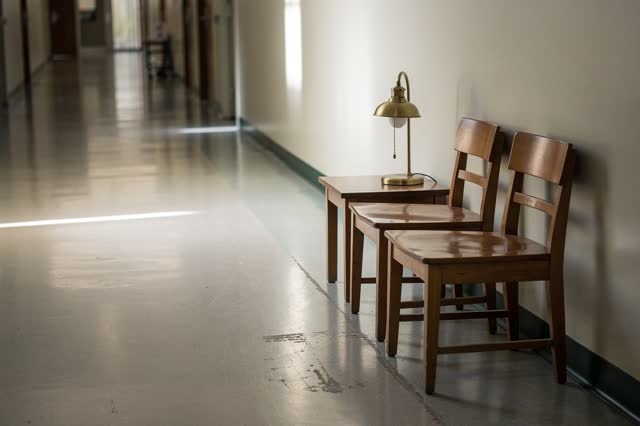 I dream that the chairs keep the room ordinary. In a public library corridor lounge after treatment traffic has ended, t