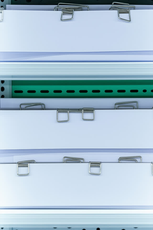 I dream that the shelf clips vote to wait. On a bright freezer staging counter, small aluminum shelf clips have arranged