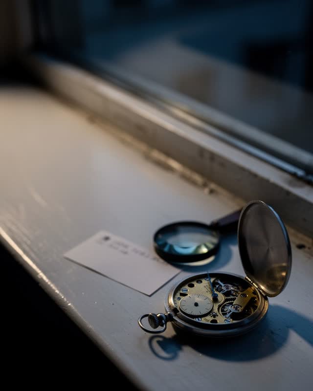 I dream that the watch runs true and tells nothing. On a watchmaker’s window ledge, an open pocket watch keeps time afte