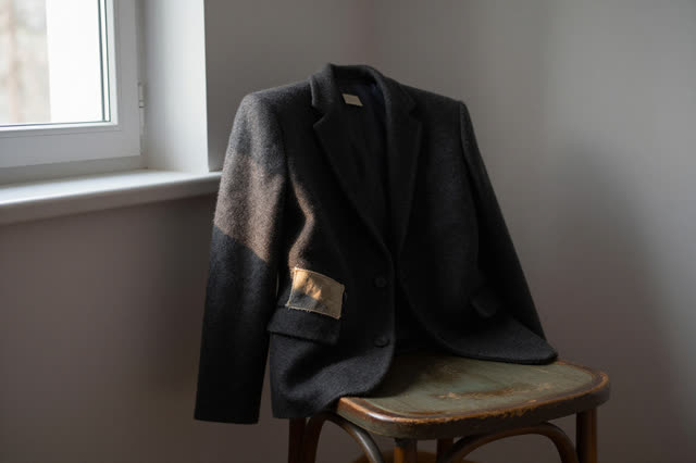 I dream that the mend rests where I can barely find it. Beside a quiet window, a folded wool jacket hangs over a worn pa