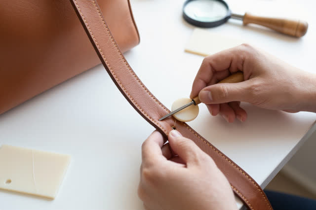I dream that I hide strength under the strap. At a bright leather repair counter, careful hands fit a thin matching leat