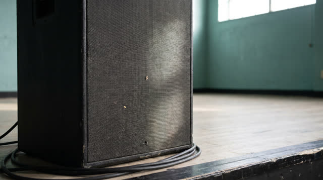 I dream that I let the grille keep one mote. In an empty community theater before rehearsal, a large speaker grille hold