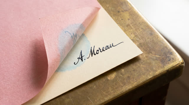 I dream that I lift only the excess. At a small public signing counter beside a bright side window, a sheet of pink blot