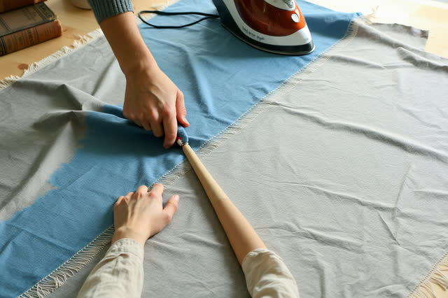 I dream that I press without flattening the crease. In a bright alteration room beside a public costume closet, careful