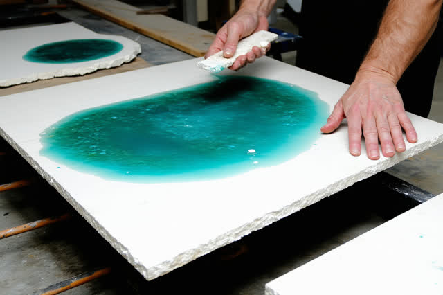 I dream that I let the tile stop shining. In a community ceramics room, a repaired public mosaic tile cools on a steel r
