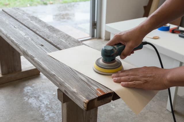 I dream that I sand around the mark. In an open-air public bench repair shed with rain drying beyond the doorway, carefu