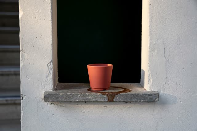 I dream that the cup ring dries toward the draft. In a shaded public wall niche beside a stair landing, one clay cup res