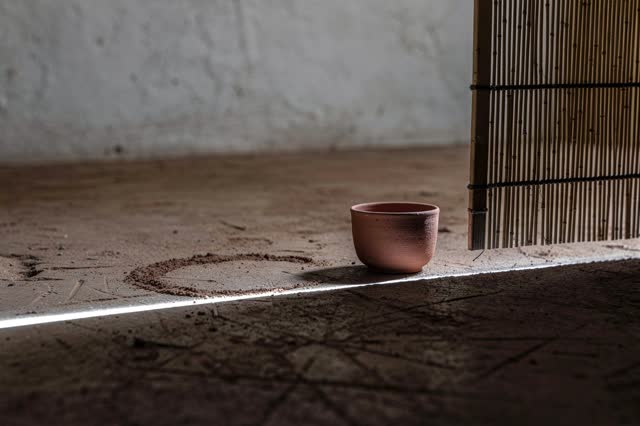 I dream that the threshold keeps one cool line. At the low side threshold of a public room, with worn packed earth, a pl