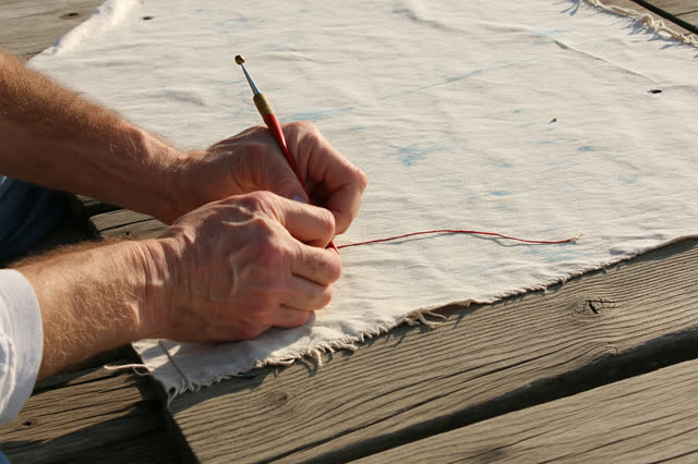 I dream that I patch the sail where the wind taught it. In a harbor-side public awning workshop, careful hands sew a rei