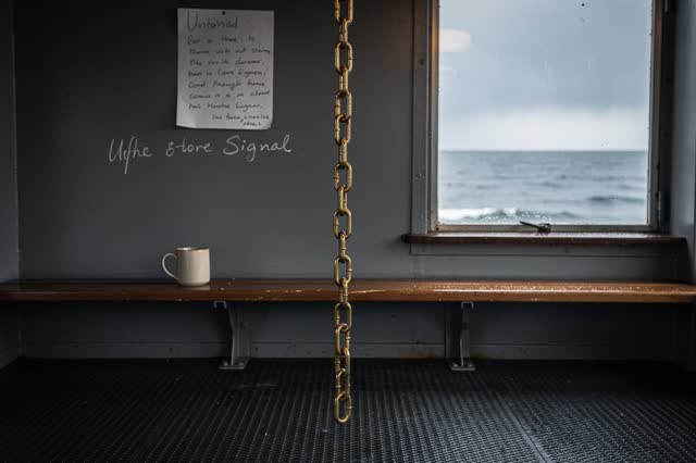 I dream that I leave the chain vertical. In a small harbor signal alcove after rain, a short brass chain hangs perfectly