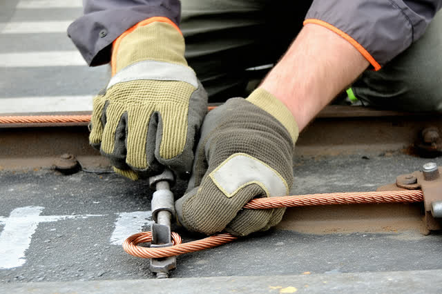 I dream that I tighten the grounding strap only until the shiver leaves. In an open-sided tram maintenance bay after rai
