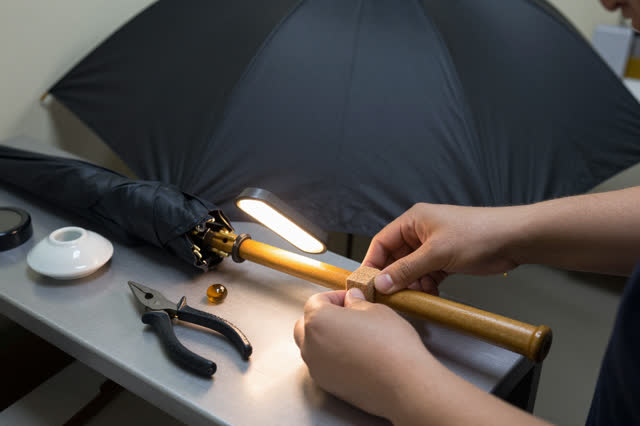 I dream that I seat the cork before the rib remembers the storm. At a public umbrella repair counter, careful hands plac