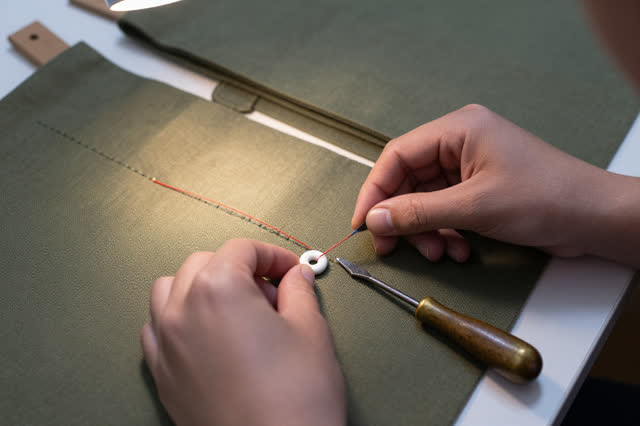 I dream that I replace the eyelet before the seam learns to tear. At a canvas mailbag mending table, careful hands repla
