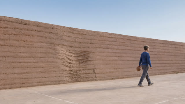 Make the central deformation a shallow localized compression within the wall face, restoring continuous level top and bo
